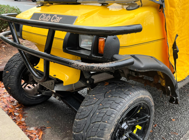 yellow Club Car DS with fender flares, brush guard and yellow enclosure