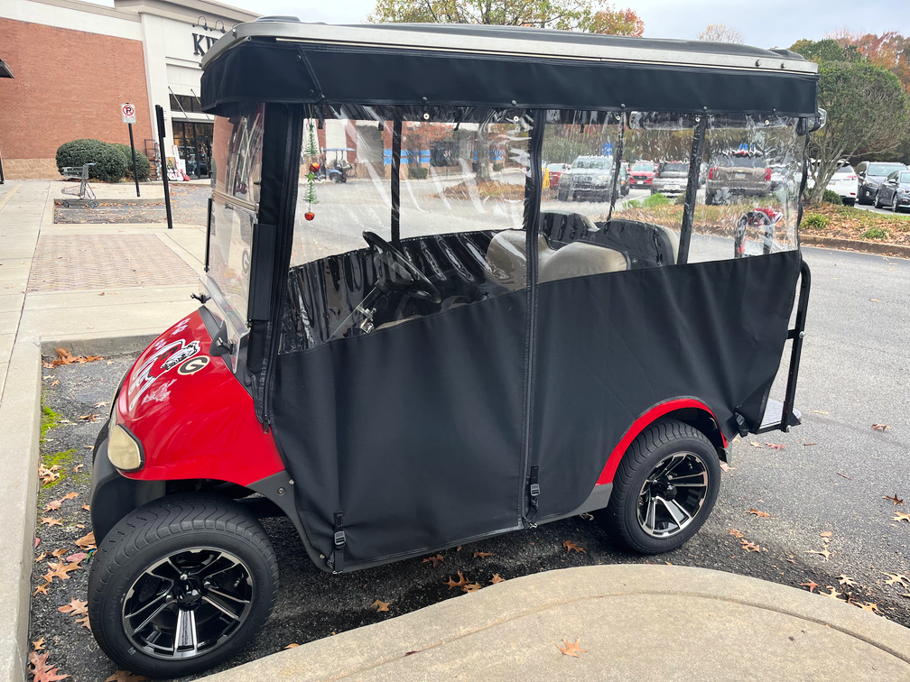 black ez go golf cart enclosure on red golf cart