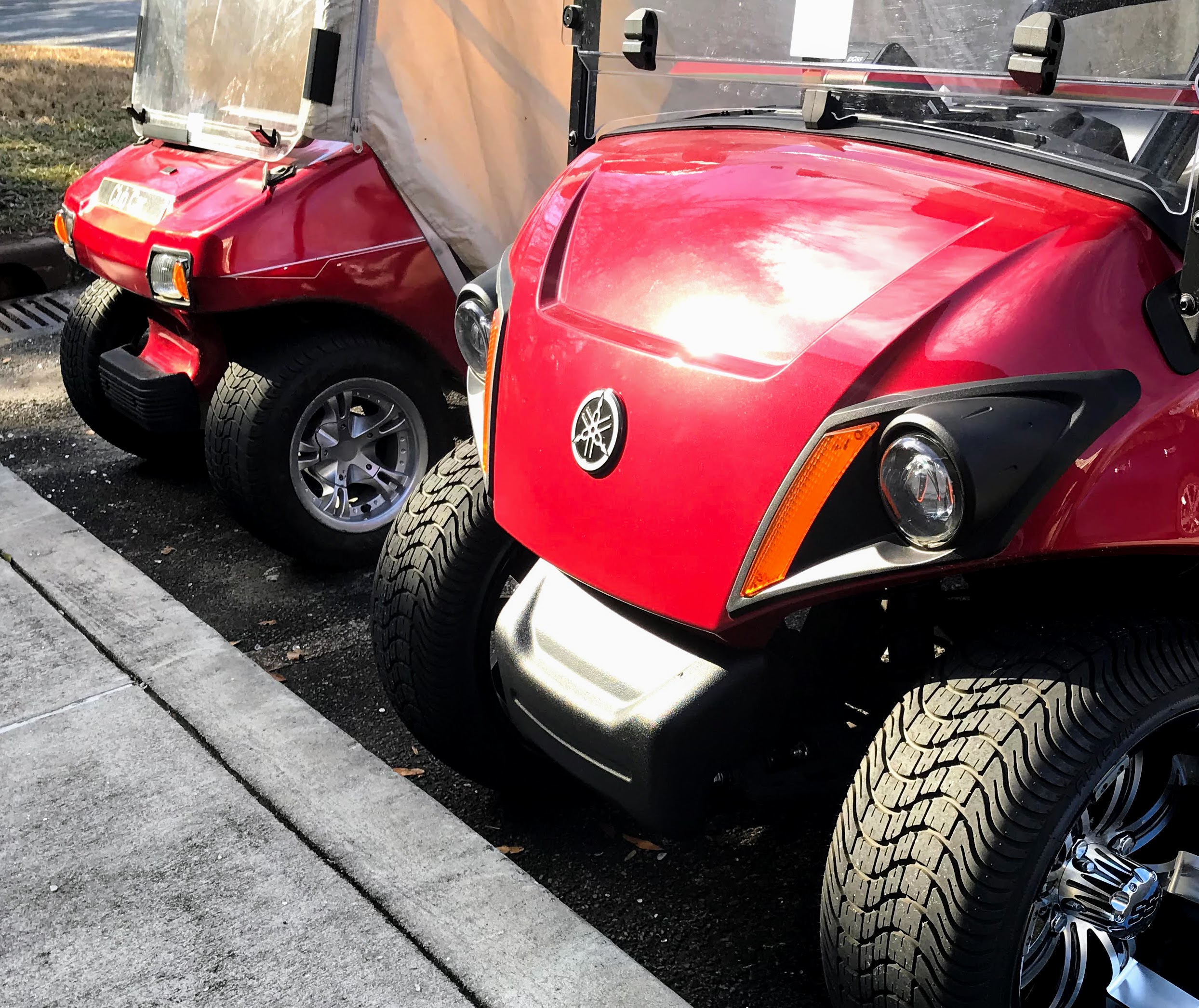 a red Club Car DS and a red Yamaha golf cart body