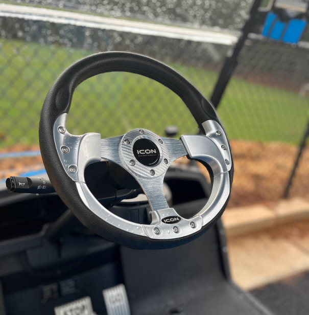 black and silver golf cart steering wheel