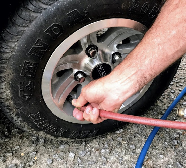 tire pressure gauge measuring pressure of golf cart tire